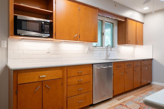 14 Grandview Dr, Normal, IL 61761 - kitchen with appliances with stainless steel finishes, light wood-type flooring, light countertops, and backsplash