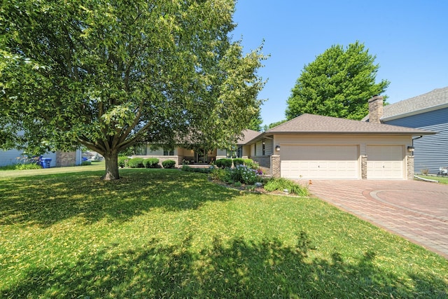 541 Donald St, Hinckley, IL 60520 - view of front of house with decorative driveway, a front lawn, a garage, and brick siding