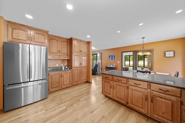 541 Donald St, Hinckley, IL 60520 - kitchen with freestanding refrigerator, light wood finished floors, recessed lighting, decorative light fixtures, and dark stone counters
