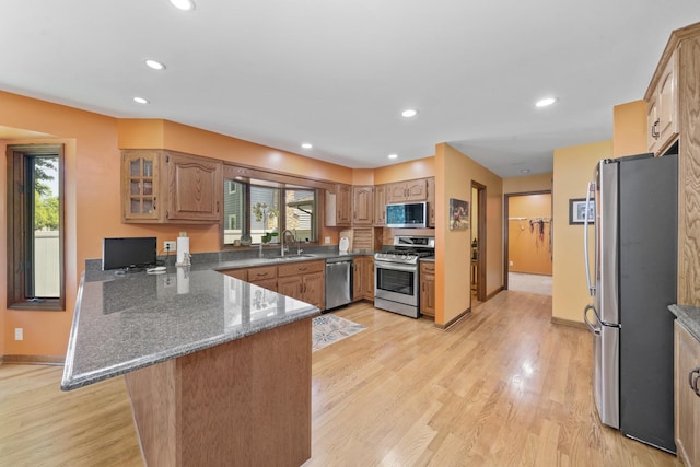 541 Donald St, Hinckley, IL 60520 - kitchen with stainless steel appliances, a peninsula, dark stone counters, light wood-style floors, and recessed lighting