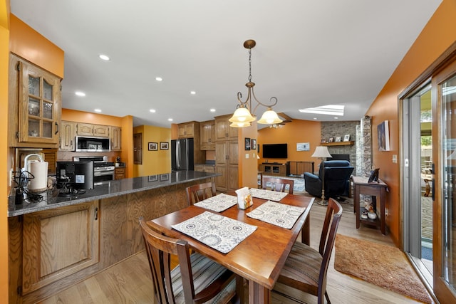 541 Donald St, Hinckley, IL 60520 - dining space with light wood-type flooring, a large fireplace, and recessed lighting