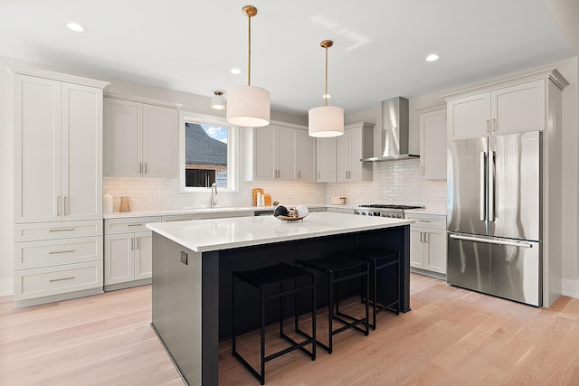 11049 Lizmore Ln Unit 40B, Orland Park, IL 60467 - kitchen with high quality fridge, wall chimney range hood, a kitchen island, tasteful backsplash, and light countertops