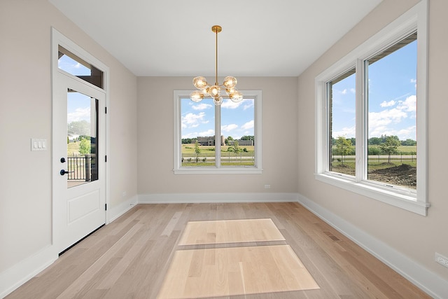 11049 Lizmore Ln Unit 40B, Orland Park, IL 60467 - unfurnished dining area featuring light wood finished floors and a chandelier