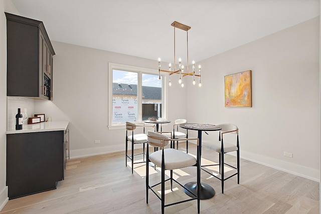 11049 Lizmore Ln Unit 40B, Orland Park, IL 60467 - dining room featuring light wood finished floors, a chandelier, and bar area