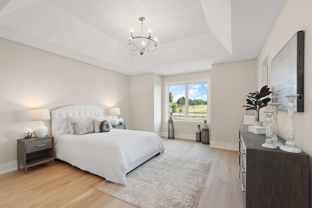 11049 Lizmore Ln Unit 40B, Orland Park, IL 60467 - bedroom featuring a chandelier, light wood-style flooring, and a tray ceiling