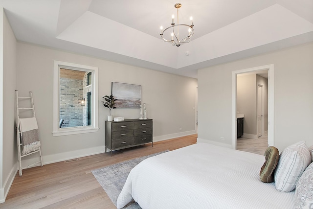 11049 Lizmore Ln Unit 40B, Orland Park, IL 60467 - bedroom featuring a chandelier, light wood-style flooring, connected bathroom, and a raised ceiling