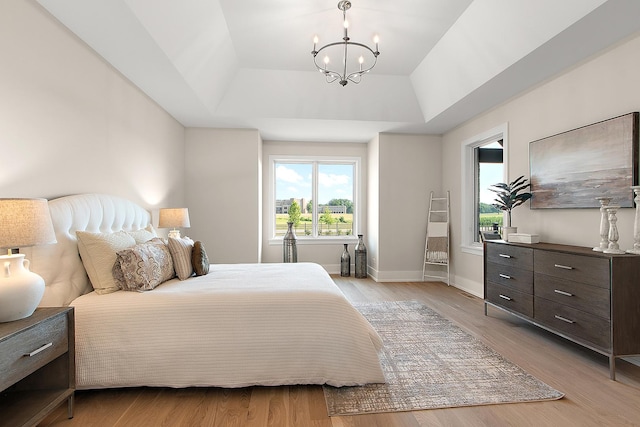 11049 Lizmore Ln Unit 40B, Orland Park, IL 60467 - bedroom featuring a tray ceiling, multiple windows, a chandelier, and light wood-style floors