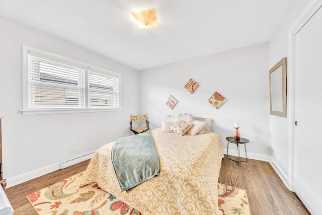3052 W 100th St, Evergreen Park, IL 60805 - bedroom featuring wood finished floors and a baseboard radiator