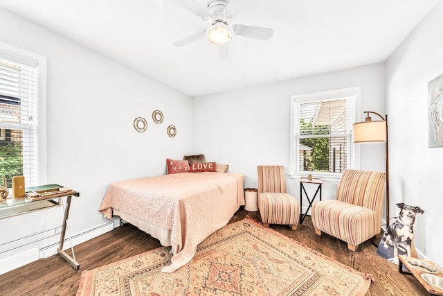 3052 W 100th St, Evergreen Park, IL 60805 - bedroom with wood finished floors, a baseboard radiator, and ceiling fan