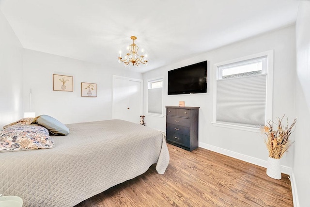 3052 W 100th St, Evergreen Park, IL 60805 - bedroom with light wood finished floors, a chandelier, multiple windows, and a closet