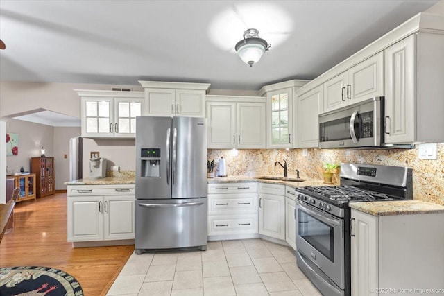 8011 Lawler Ave, Burbank, IL 60459 - kitchen with stainless steel appliances, tasteful backsplash, glass insert cabinets, and light stone countertops
