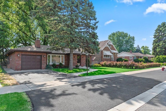 8011 Lawler Ave, Burbank, IL 60459 - view of front of property with an attached garage, asphalt driveway, brick siding, a front yard, and a chimney