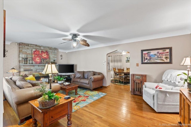8011 Lawler Ave, Burbank, IL 60459 - living room featuring ceiling fan, light wood finished floors, and arched walkways