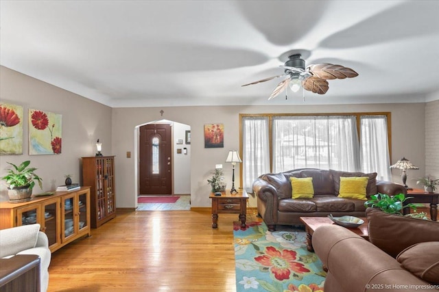 8011 Lawler Ave, Burbank, IL 60459 - living room featuring arched walkways, a ceiling fan, and light wood-style floors