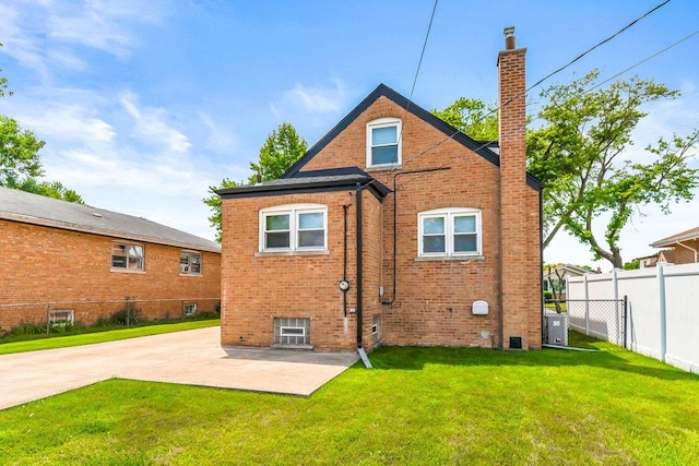 10817 S Kenneth Ave, Oak Lawn, IL 60453 - back of property with a chimney, brick siding, and a patio