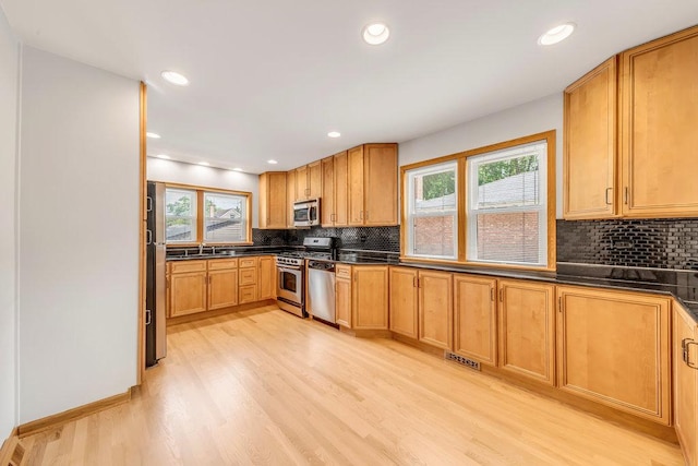 10817 S Kenneth Ave, Oak Lawn, IL 60453 - kitchen with appliances with stainless steel finishes, healthy amount of natural light, light wood-type flooring, dark countertops, and recessed lighting