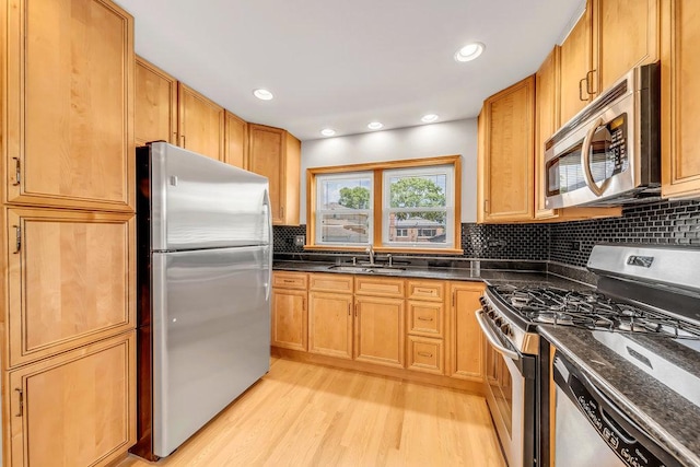 10817 S Kenneth Ave, Oak Lawn, IL 60453 - kitchen featuring appliances with stainless steel finishes, light wood-type flooring, decorative backsplash, recessed lighting, and dark stone counters