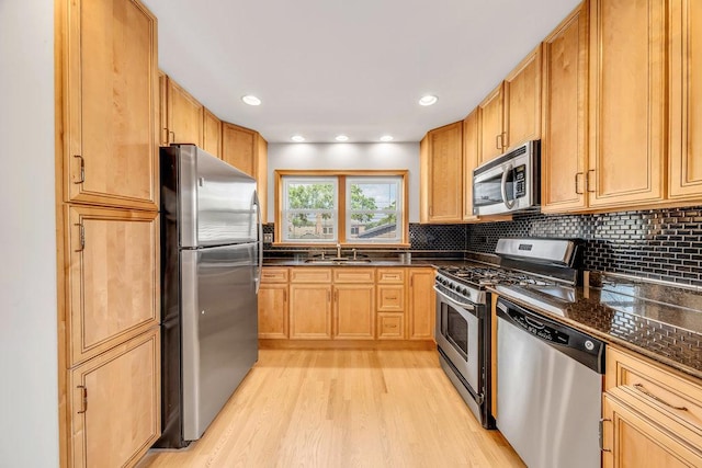 10817 S Kenneth Ave, Oak Lawn, IL 60453 - kitchen with appliances with stainless steel finishes, dark countertops, light wood-type flooring, and decorative backsplash