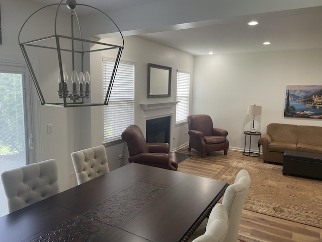 21024 W Walnut Ln, Plainfield, IL 60544 - dining space featuring a chandelier, wood finished floors, plenty of natural light, recessed lighting, and a fireplace
