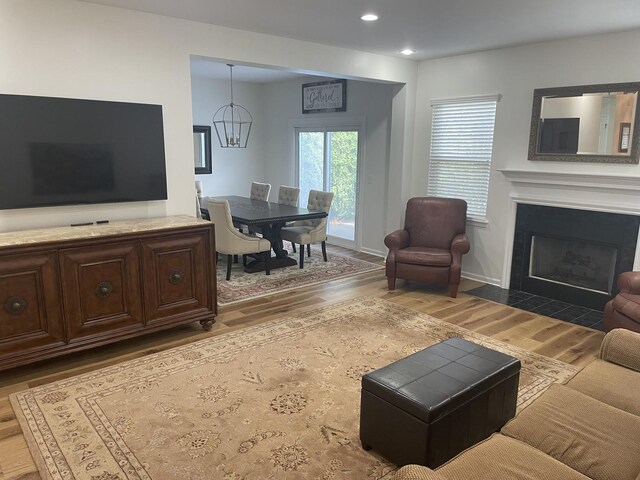 21024 W Walnut Ln, Plainfield, IL 60544 - living room with wood finished floors, a fireplace with flush hearth, recessed lighting, and a chandelier