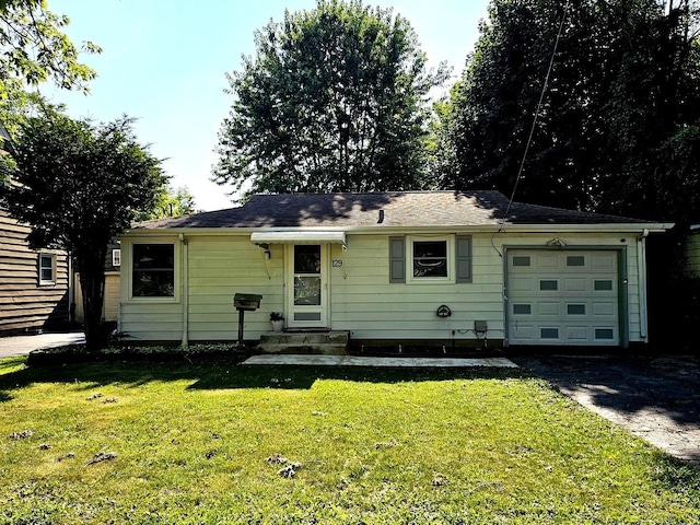 129 S Commonwealth Ave, Elgin, IL 60123 - view of front of property featuring a garage, asphalt driveway, and a front yard