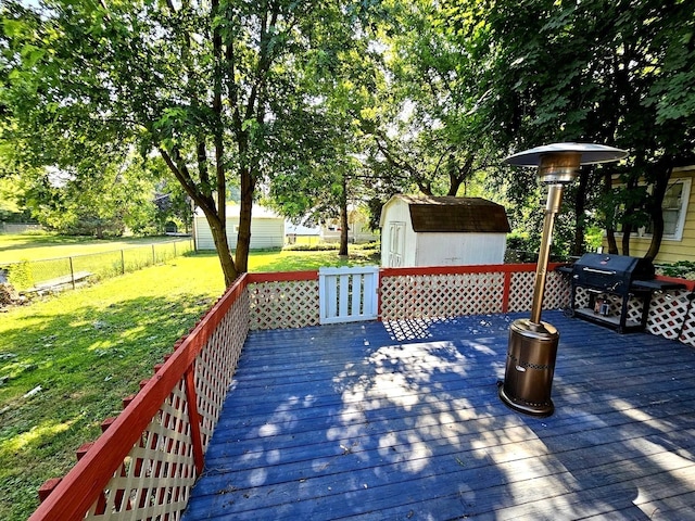 129 S Commonwealth Ave, Elgin, IL 60123 - wooden deck featuring a storage shed, a fenced backyard, and a grill