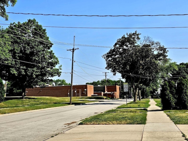 129 S Commonwealth Ave, Elgin, IL 60123 - view of asphalt road featuring sidewalks, curbs, and traffic signs