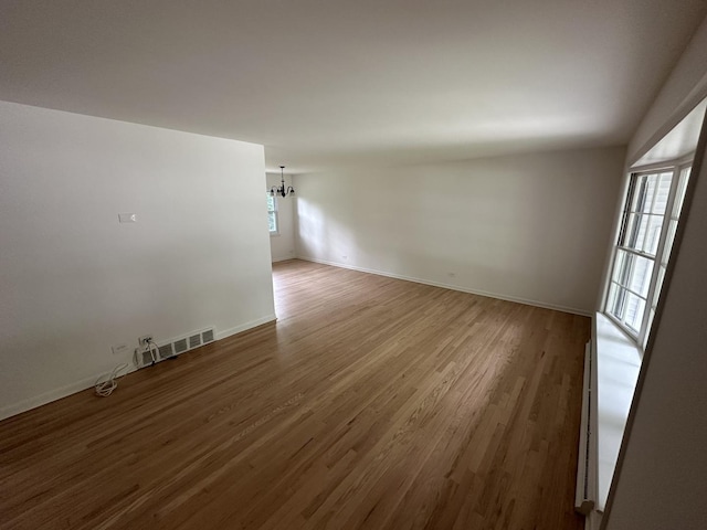 1028 Castlewood Ln, Deerfield, IL 60015 - spare room featuring a chandelier and wood finished floors