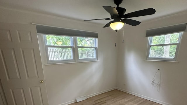 1028 Castlewood Ln, Deerfield, IL 60015 - unfurnished room with light wood-type flooring, crown molding, and ceiling fan