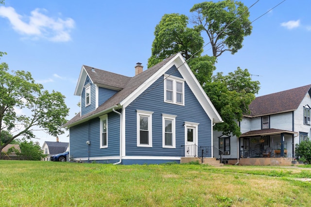 444 Villa St, Elgin, IL 60120 - rear view of property featuring a chimney, a shingled roof, and a lawn
