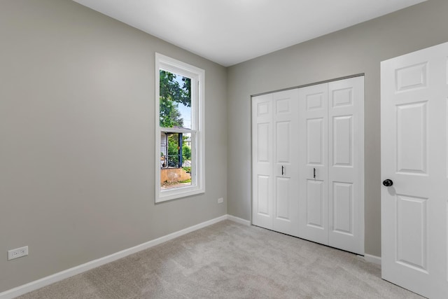 444 Villa St, Elgin, IL 60120 - unfurnished bedroom with light carpet and a closet
