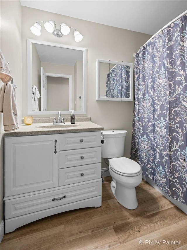 404 Kensington Dr, Mchenry, IL 60050 - bathroom featuring wood finished floors, vanity, and curtained shower