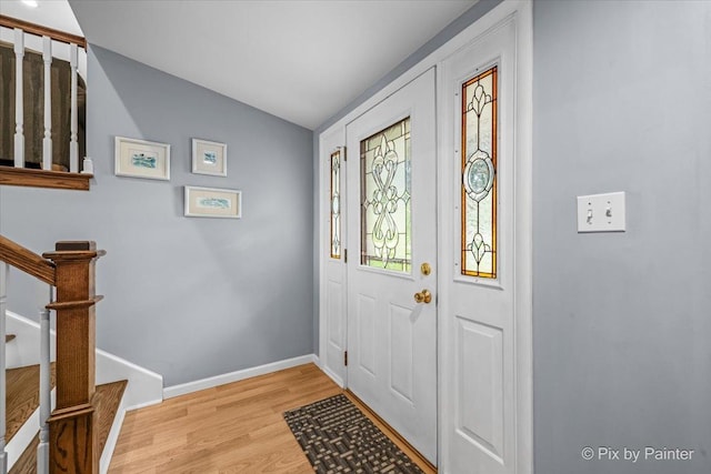 404 Kensington Dr, Mchenry, IL 60050 - foyer with light wood-type flooring, stairway, and vaulted ceiling