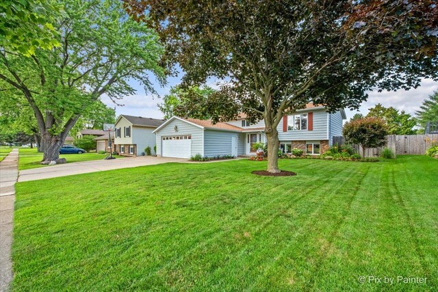404 Kensington Dr, Mchenry, IL 60050 - tri-level home with concrete driveway and a garage