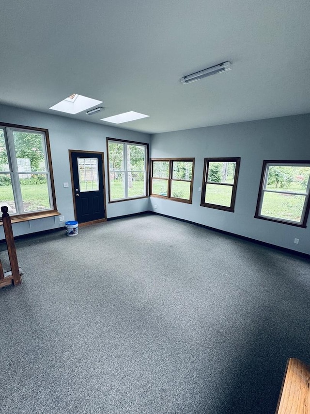 5907 Kirkwood Dr, Rockford, IL 61109 - carpeted empty room with a skylight and plenty of natural light