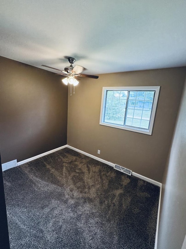 5907 Kirkwood Dr, Rockford, IL 61109 - spare room with ceiling fan and dark colored carpet