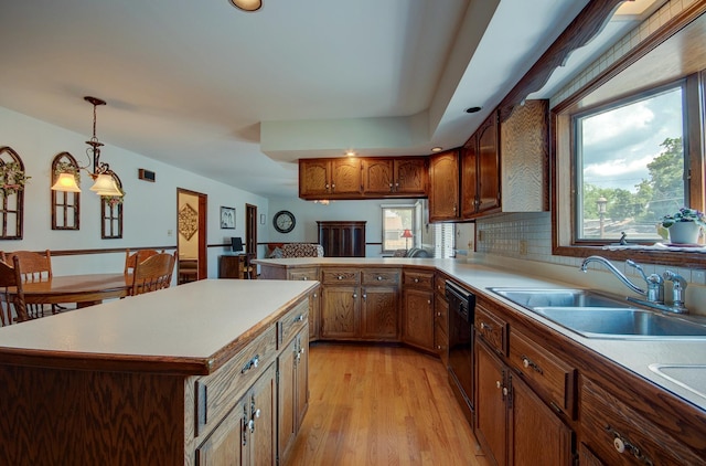 900 Mason Ave, Joliet, IL 60435 - kitchen with dishwasher, light wood finished floors, brown cabinetry, and light countertops