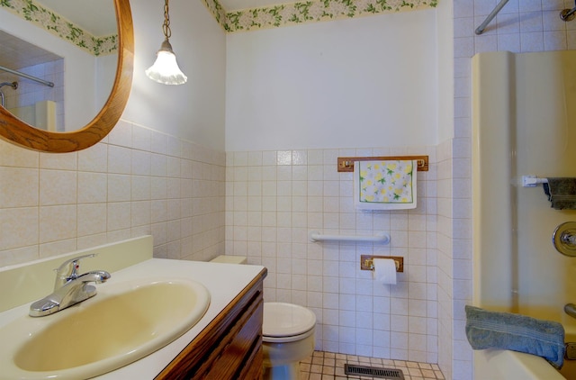 900 Mason Ave, Joliet, IL 60435 - bathroom with tile walls, a shower, vanity, and tile patterned flooring