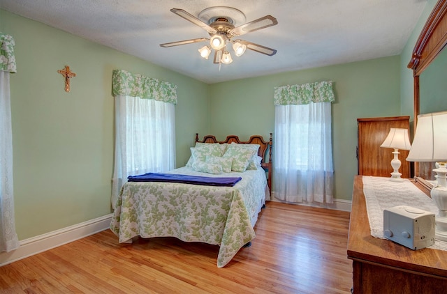 900 Mason Ave, Joliet, IL 60435 - bedroom featuring multiple windows, light wood finished floors, and ceiling fan