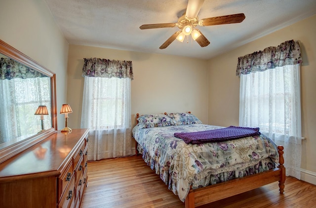900 Mason Ave, Joliet, IL 60435 - bedroom featuring light wood-style floors, multiple windows, and a ceiling fan