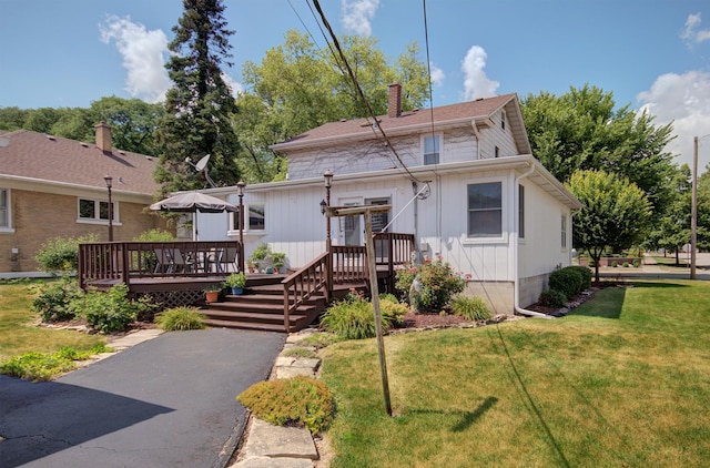 900 Mason Ave, Joliet, IL 60435 - view of front of house featuring a wooden deck, a front lawn, and a chimney