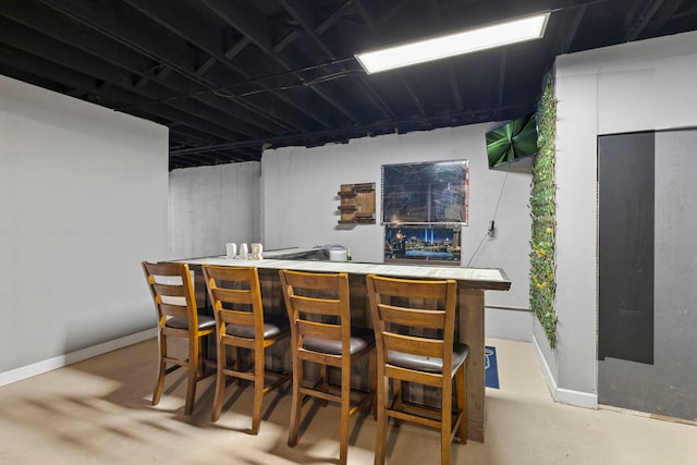 16260 W Mohawk Ct, Lockport, IL 60441 - indoor dry bar with finished concrete floors and baseboards