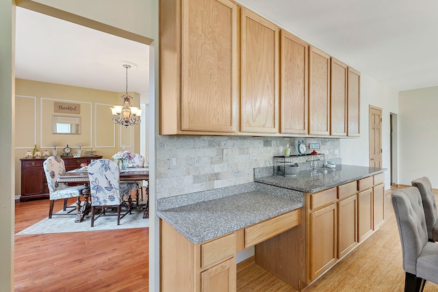 16260 W Mohawk Ct, Lockport, IL 60441 - kitchen featuring light wood finished floors, a chandelier, tasteful backsplash, light brown cabinets, and dark stone countertops