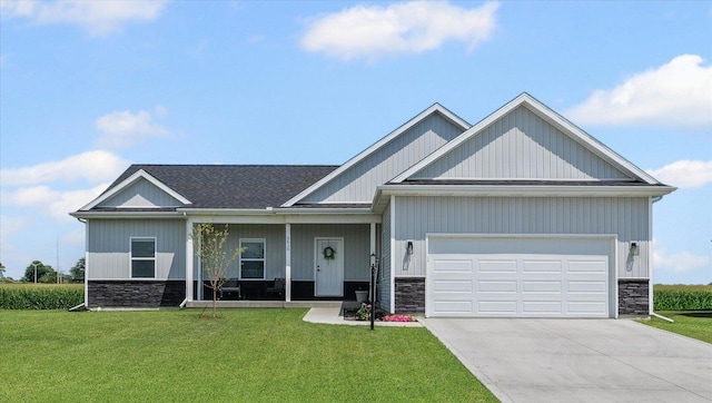 3610 Freedom Blvd, Champaign, IL 61822 - view of front of house featuring stone siding, a front yard, and an attached garage