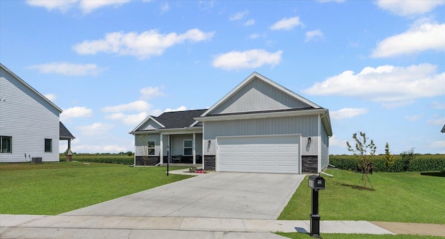 3610 Freedom Blvd, Champaign, IL 61822 - view of front facade with stone siding, a front yard, an attached garage, and driveway