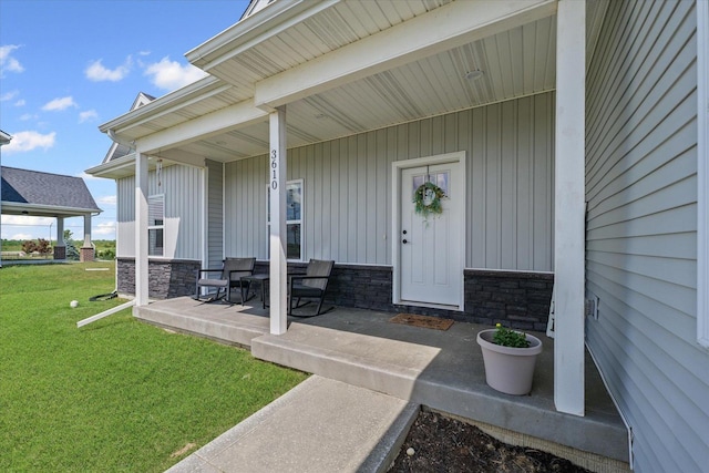 3610 Freedom Blvd, Champaign, IL 61822 - view of exterior entry featuring a porch, a yard, and stone siding