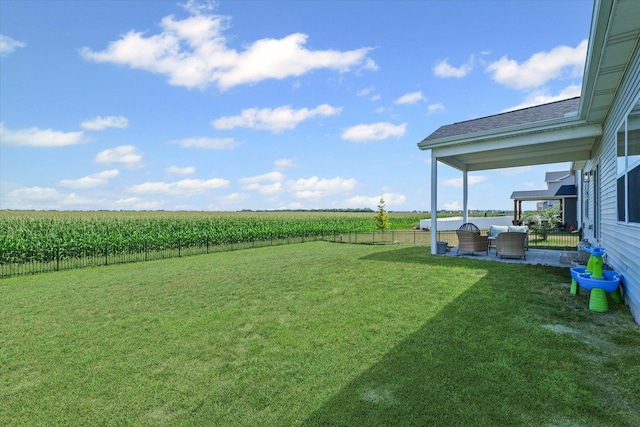 3610 Freedom Blvd, Champaign, IL 61822 - fenced backyard with agricultural area, a rural view, outdoor lounge area, and a patio area