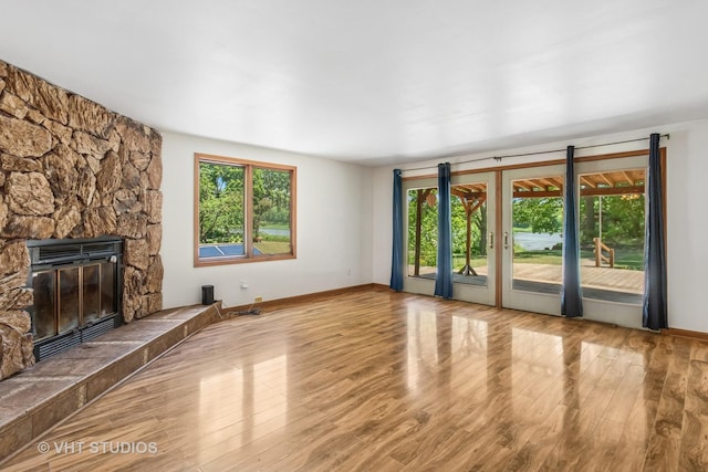 29625 N Readman Ln, Wilmington, IL 60481 - unfurnished living room featuring wood finished floors and a stone fireplace