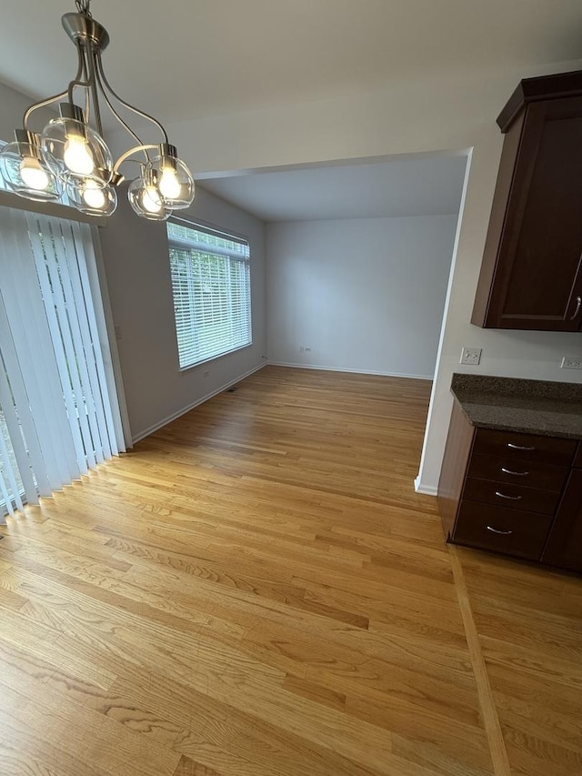 1659 Windward Ct, Naperville, IL 60563 - unfurnished dining area with light wood-style flooring and a chandelier