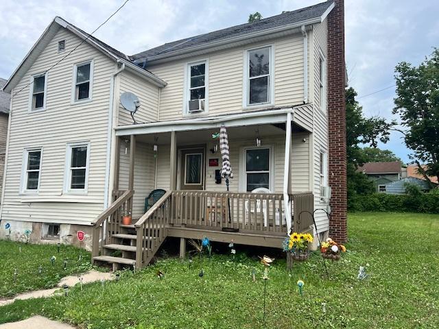 717 S Chicago Ave, Freeport, IL 61032 - view of front of home with a porch, a front yard, and a chimney